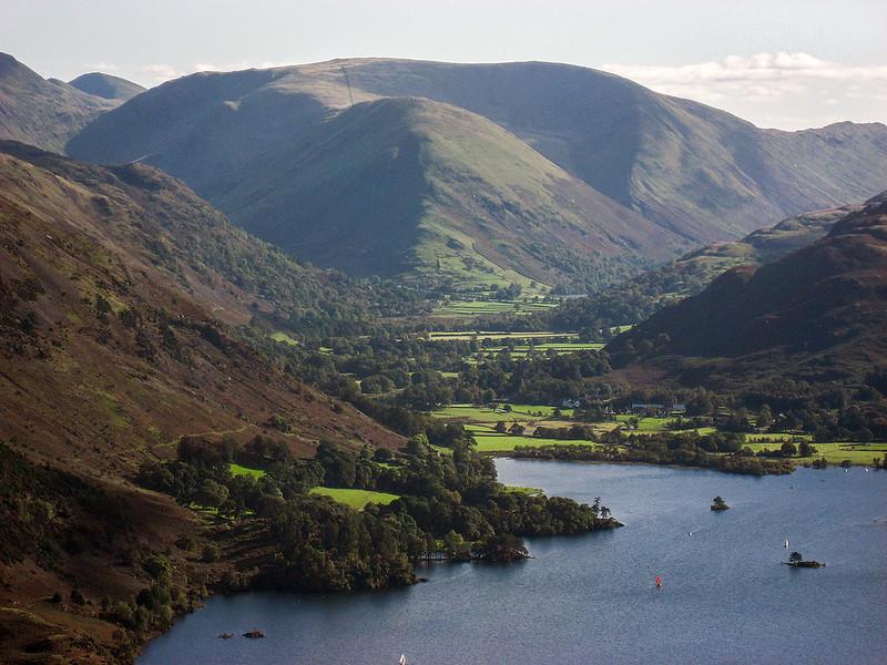 Ullswater | View of a lake surrounded by grassy hills and mountains in the Lake District, England.