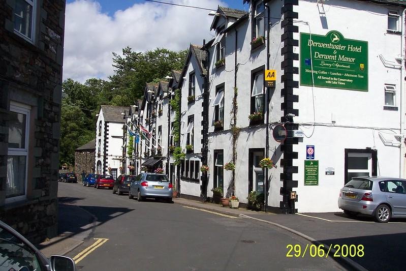 Street view of the Derwentwater Hotel with parked cars and a signboard in front of the hotel, located in a quaint area with trees in the background, taken on 29th June 2008.