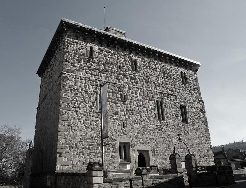 Hexham Old Gaol | Medieval stone prison with narrow windows, crenellated roofline, and an arched entranceway.