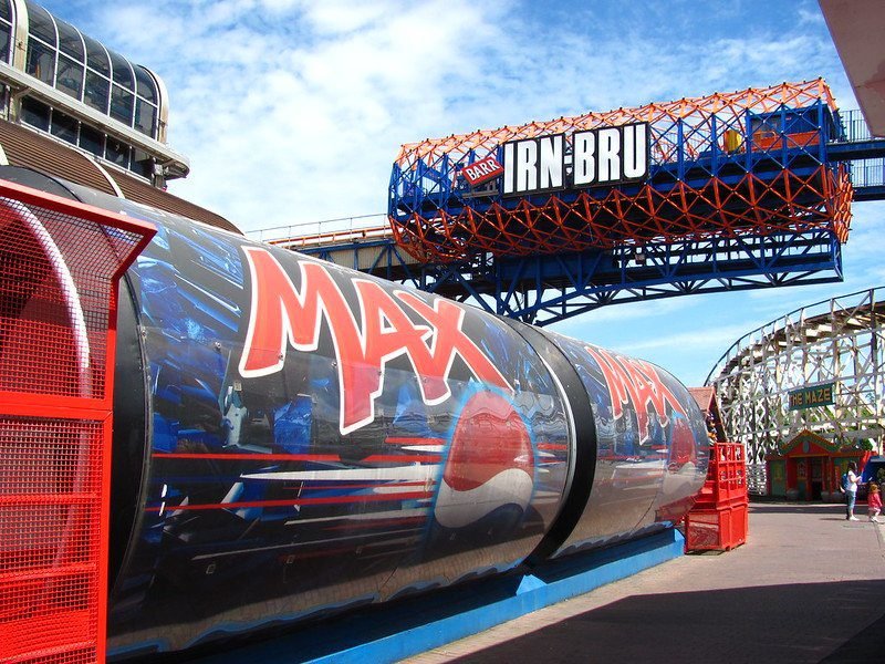 Amusement park ride with a Pepsi Max design and an IRN-BRU sign overhead.