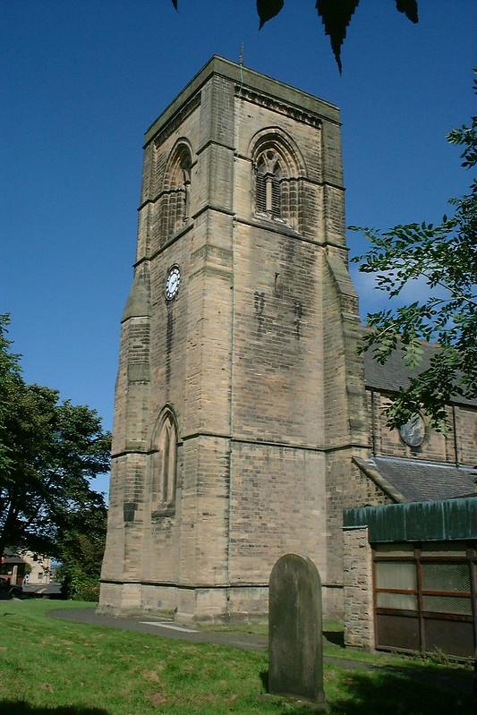 a stone tower with a clock in cramlington